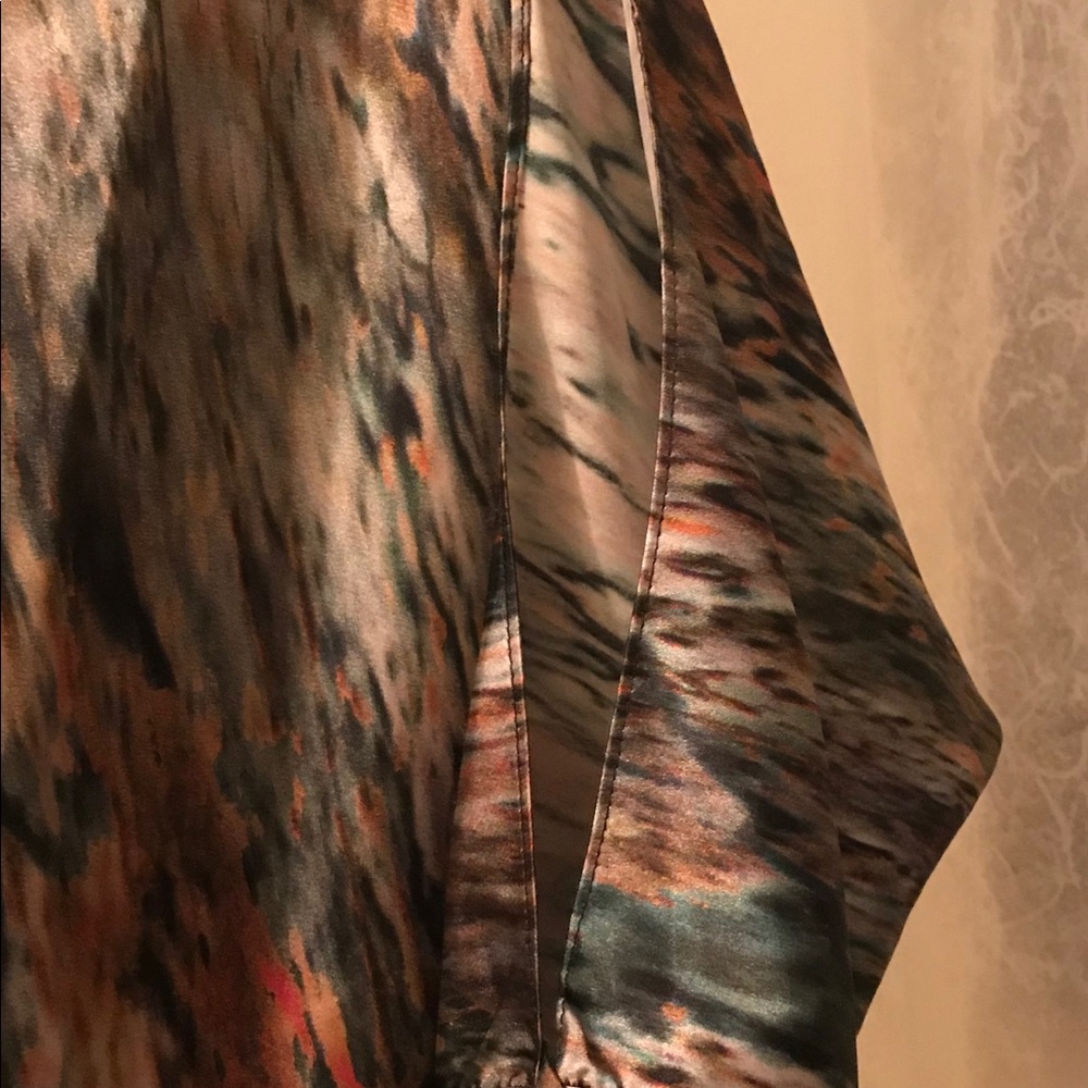 Shimmery special occasion top with slit sleeves.